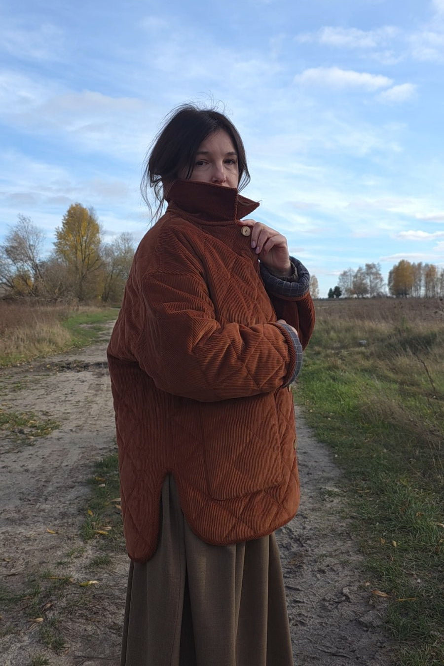 Minimalist quilted corduroy jacket for women in warm rust tone, eco inspired outerwear styled for fall spring