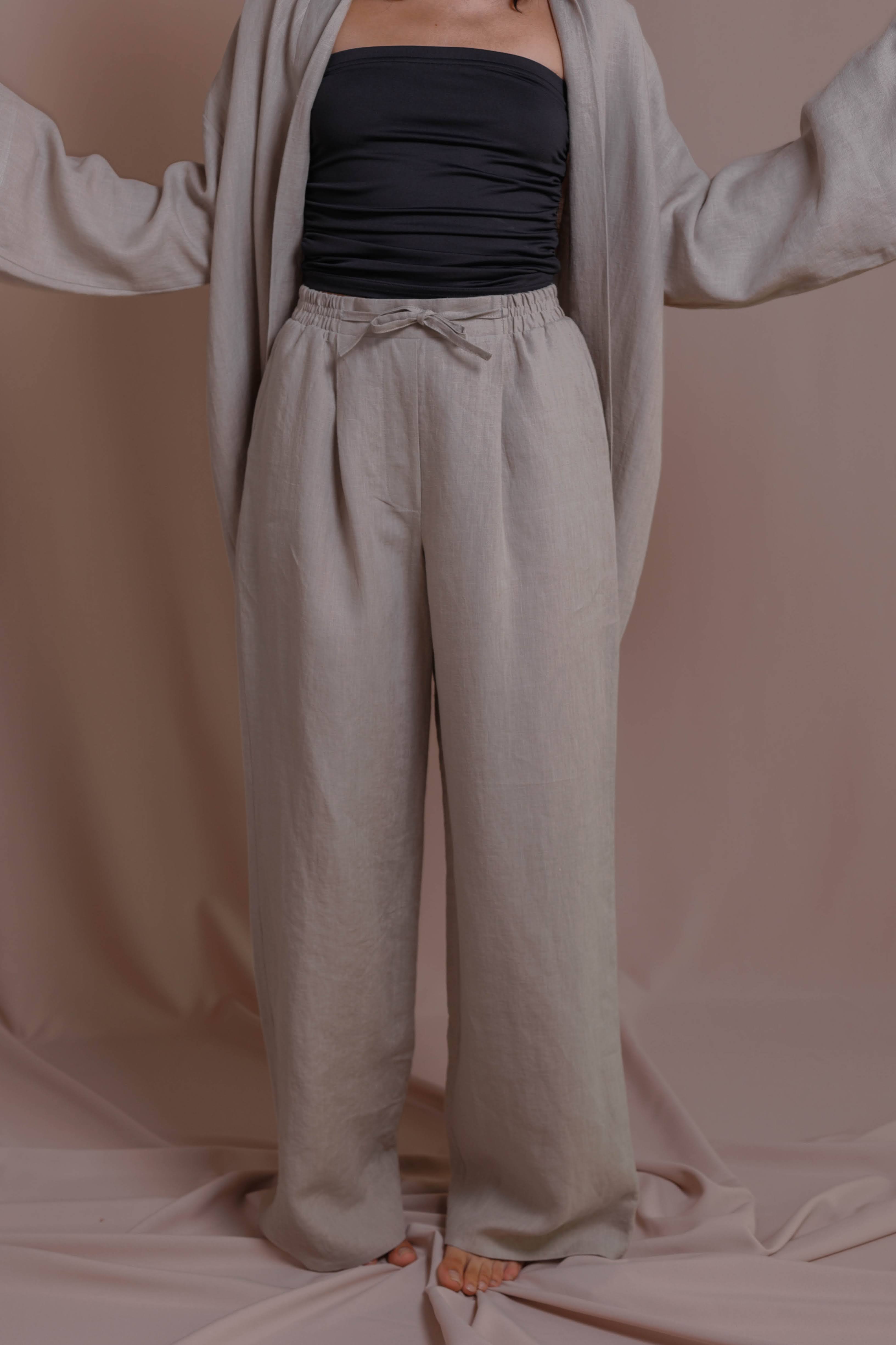 Linen trousers with elastic waistband and pocket, styled with open sleeve, crafted linen pants.