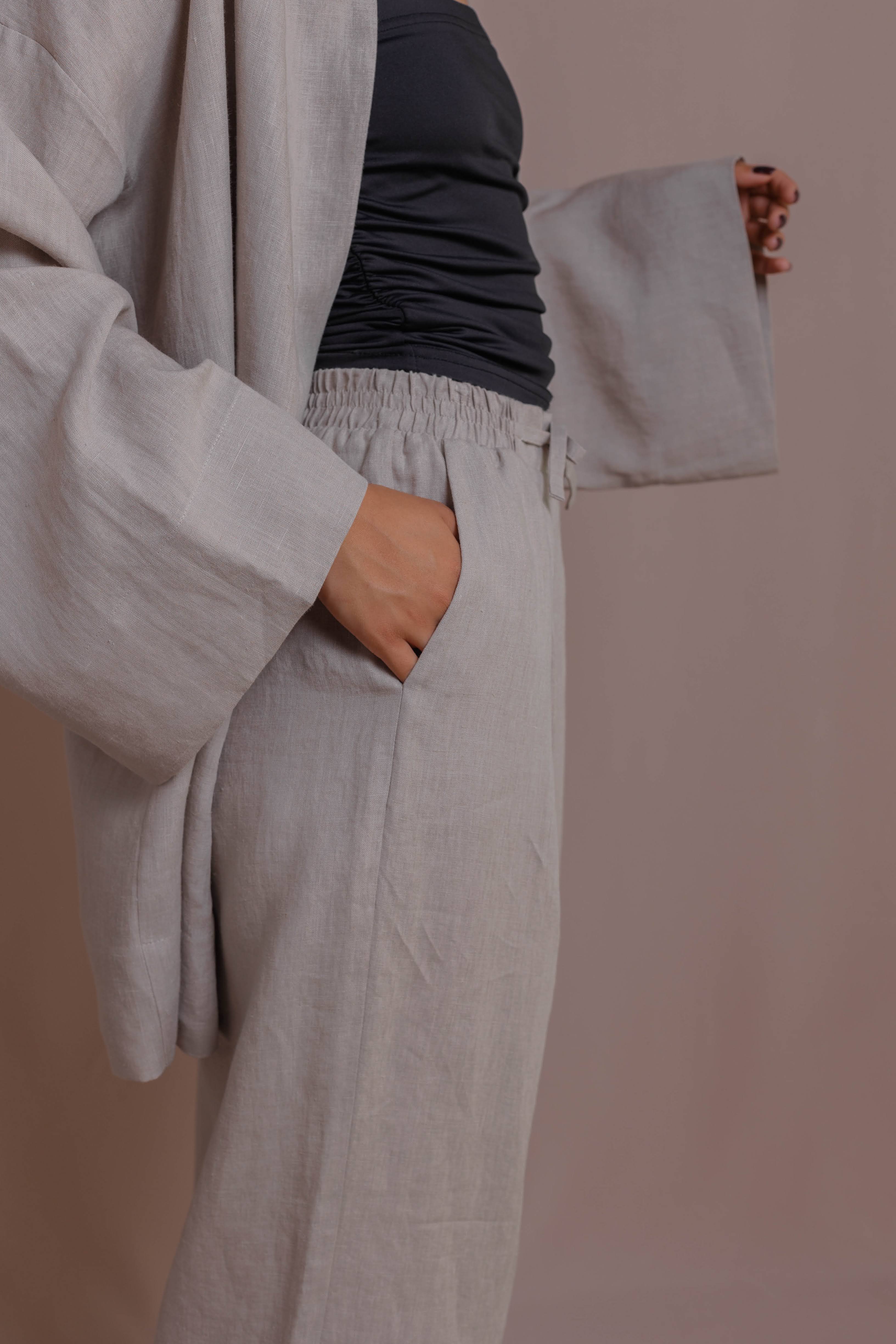 Light gray Long linen pants with elastic waistband and relaxed wide legs.