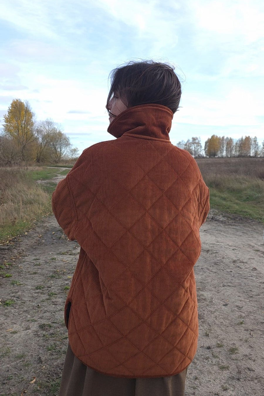 Autumn outfit with quilted corduroy jacket in earthy rust shade, minimalist slow fashion style