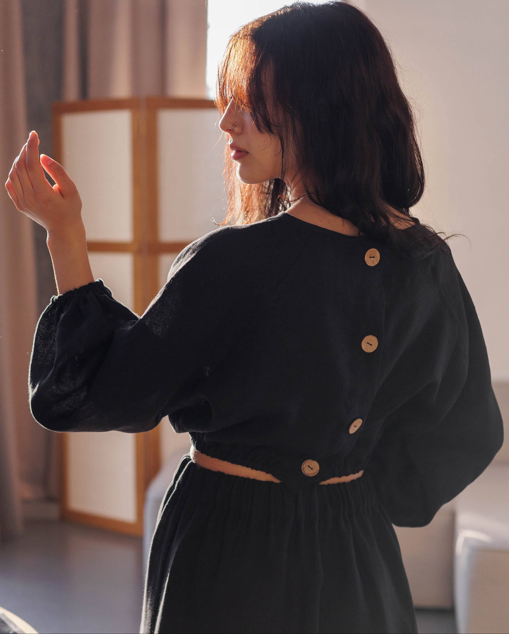 Black linen blouse with puff sleeves, elasticated hem, and coconut buttons on the back, handmade and stylish