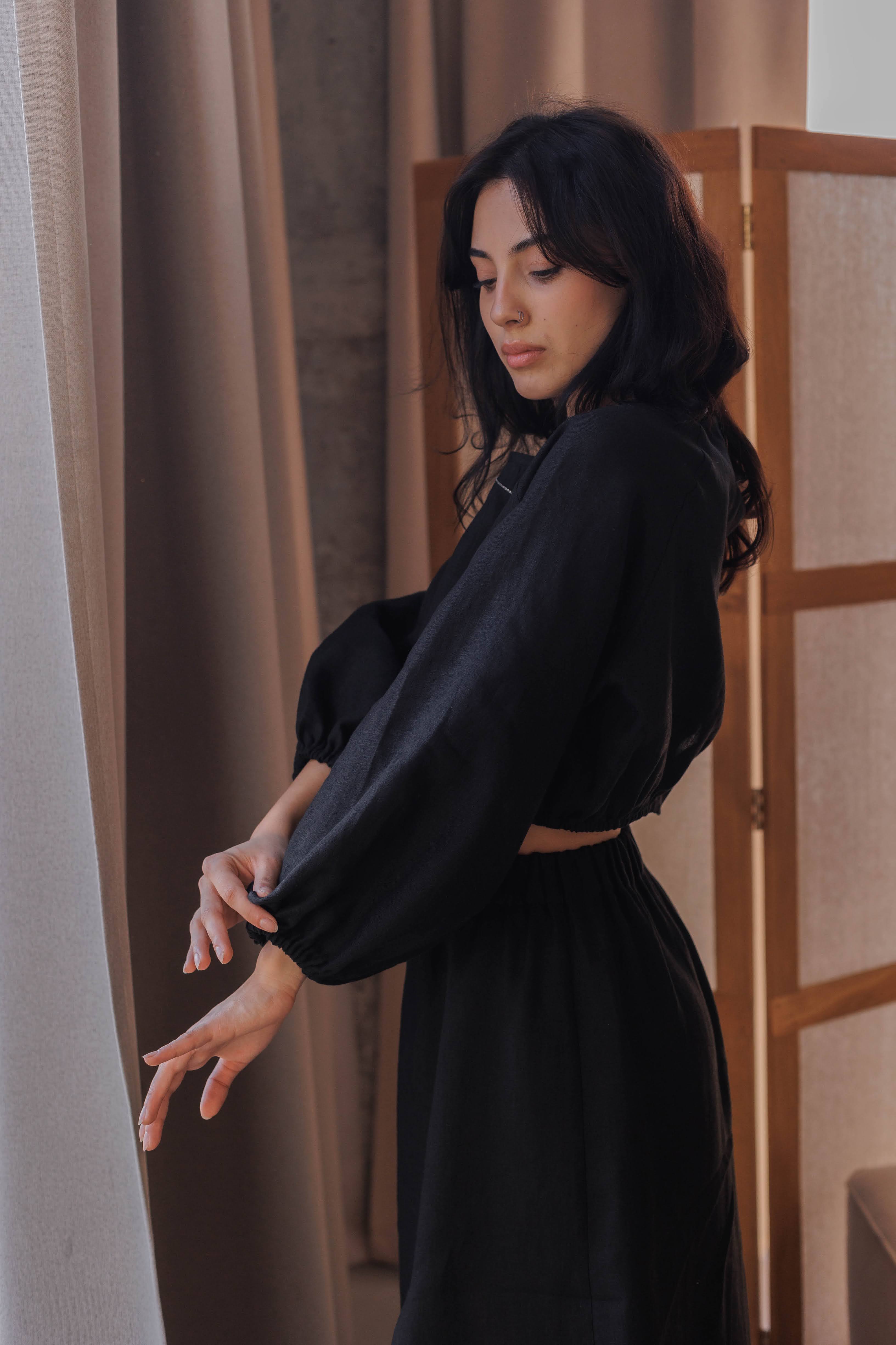 Handmade black linen blouse with airy puff sleeves and elastic hem, perfect for summer outfits.