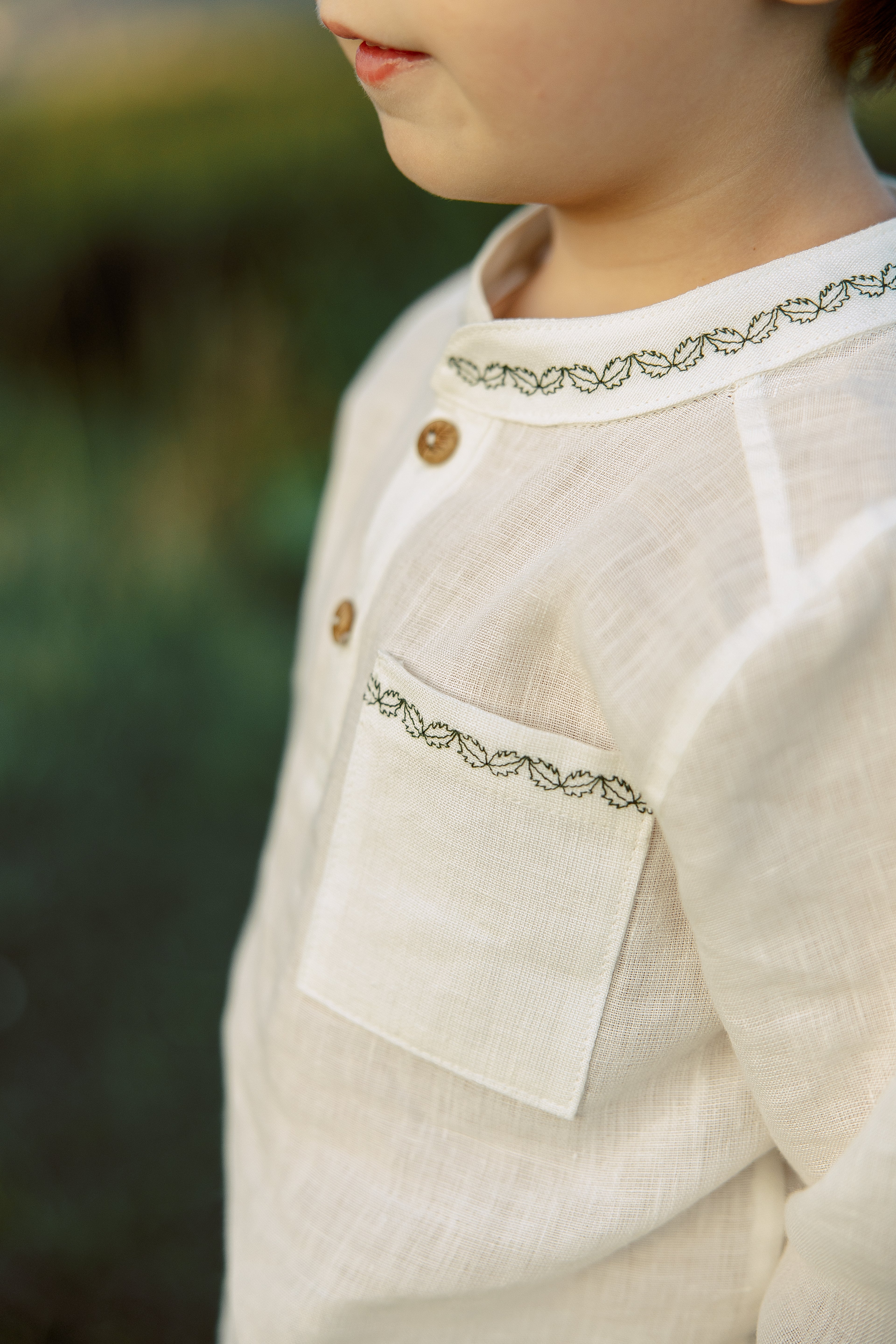 Soft and elegant linen shirt for little boys, long sleeves, subtle dark green embroidery, sustainable and natural fabric.