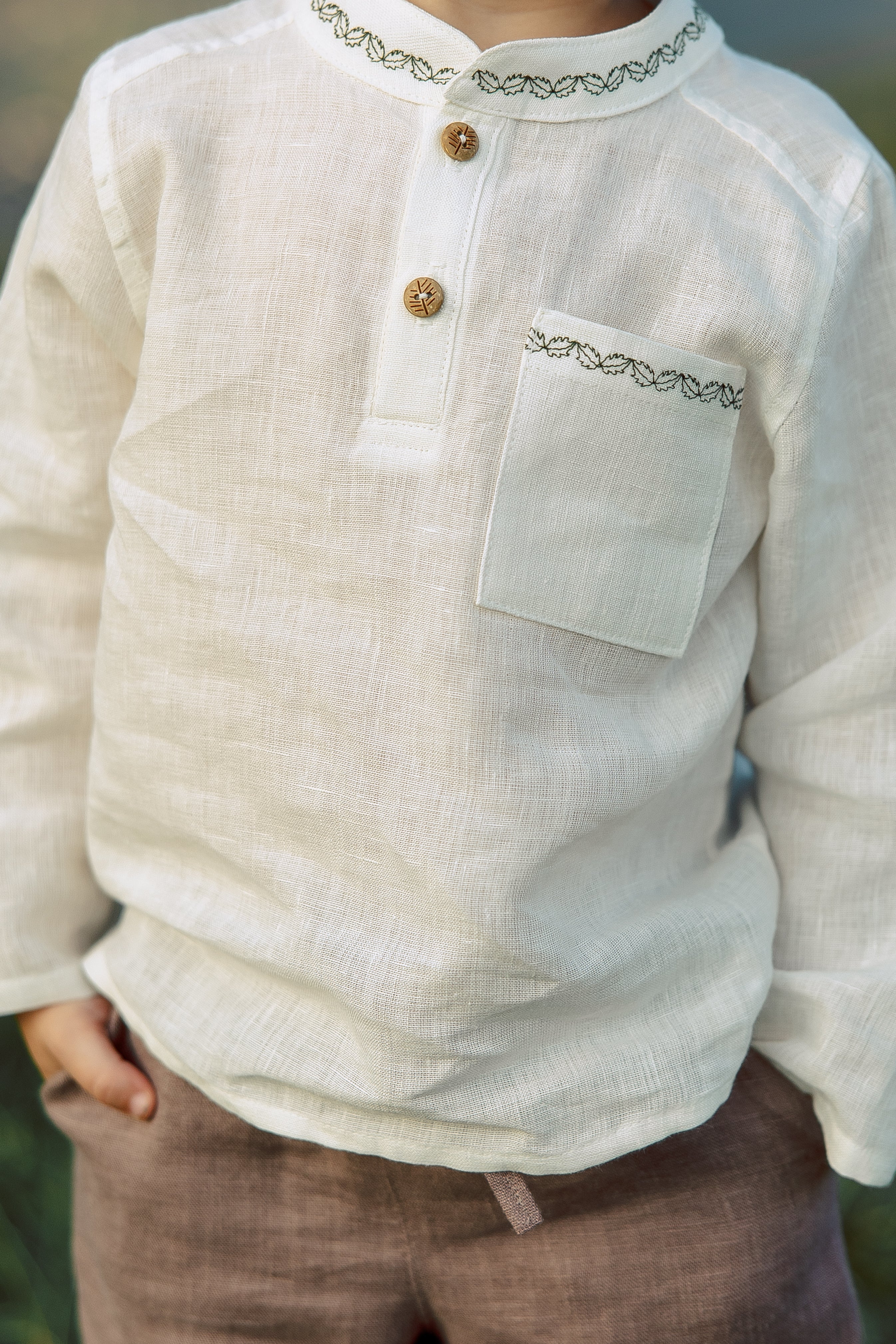 White boys’ shirt made of 100% softened linen, handmade embroidery details, perfect for formal events and casual wear.