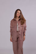 Women’s powder pink cotton corduroy shirt with oversized fit, coconut buttons, and chest flap pockets.