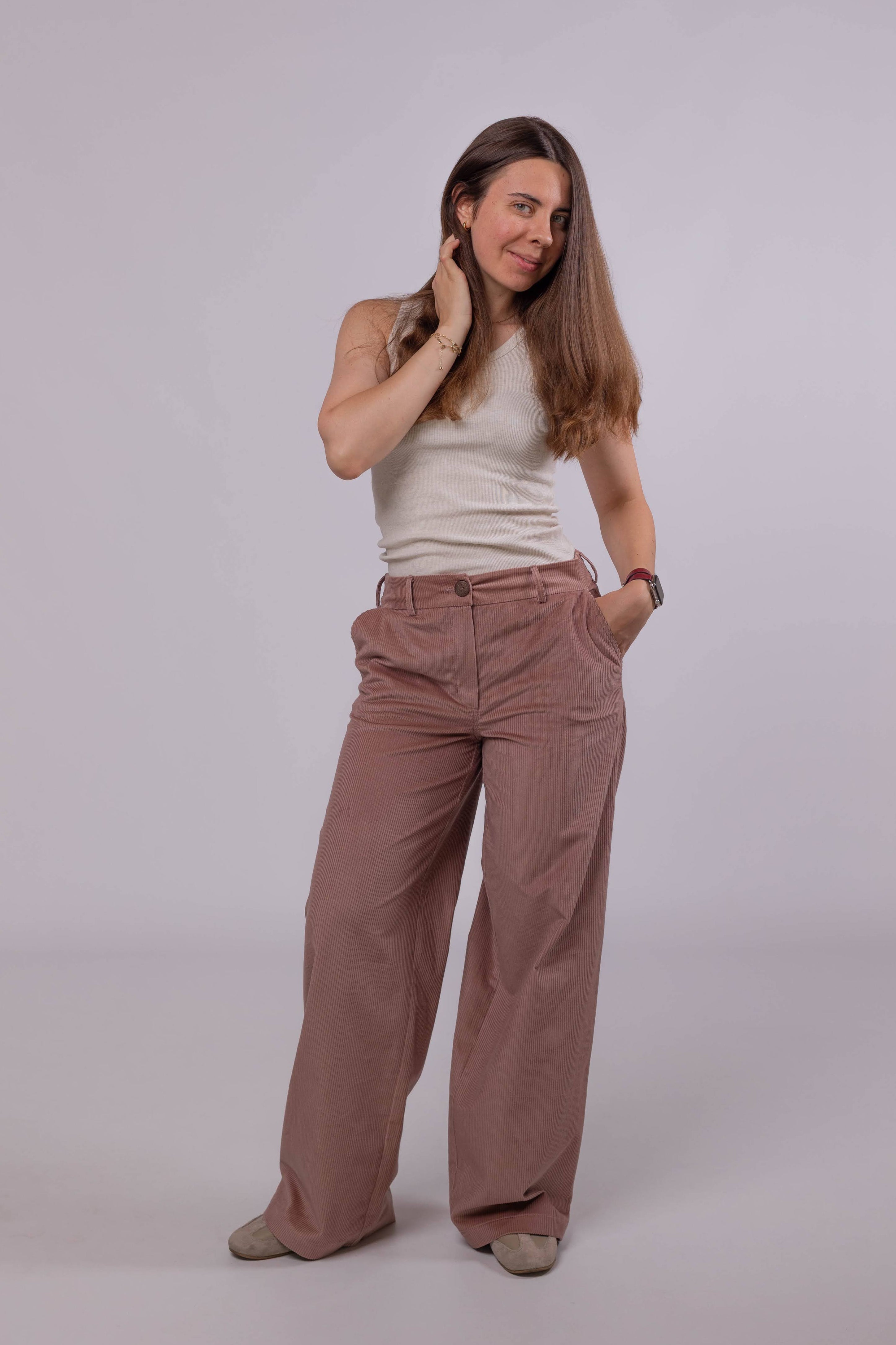 Women’s powder pink cotton corduroy pants with straight wide-leg fit and slanted side pockets.