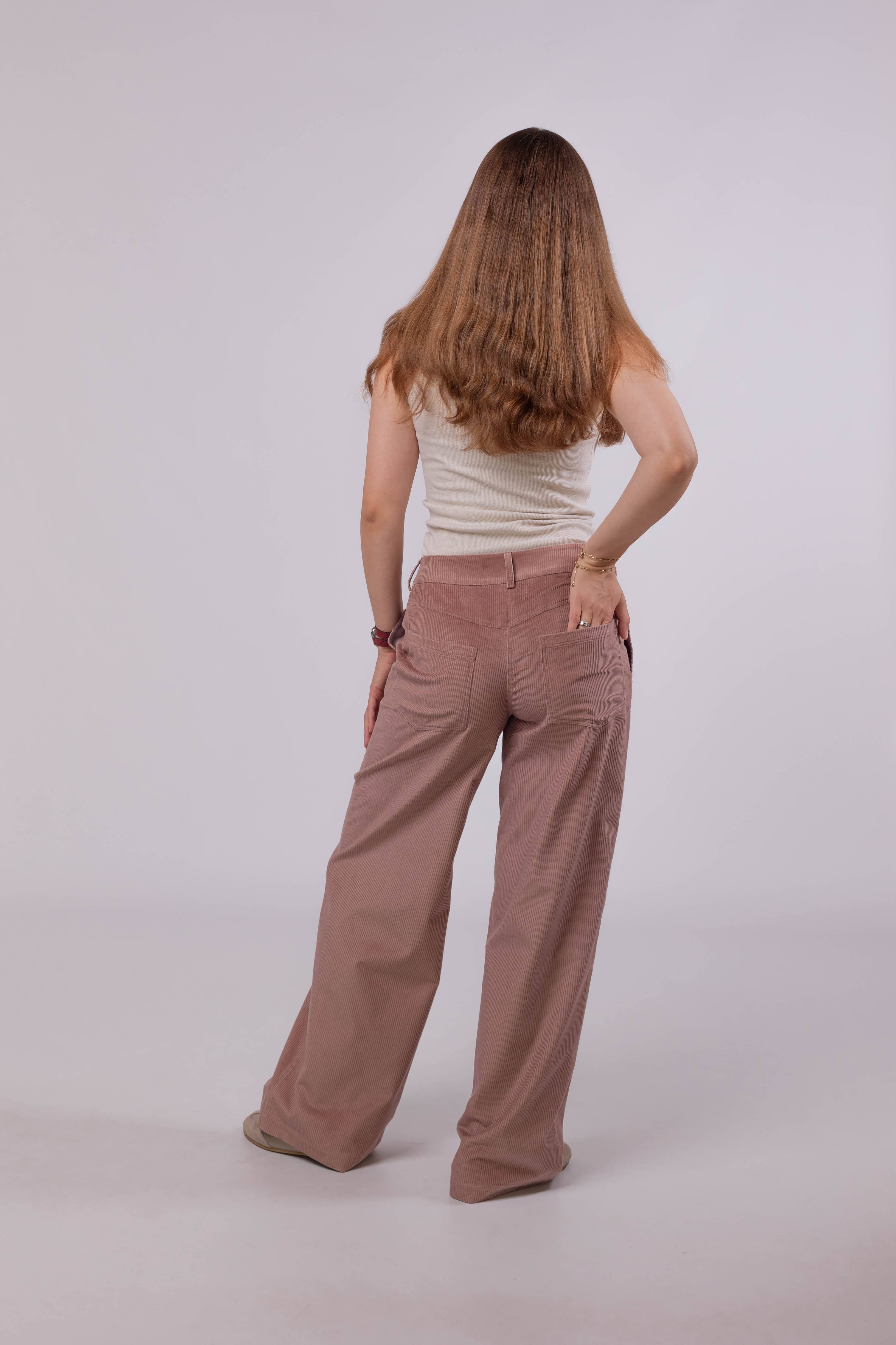 Straight-leg women’s corduroy trousers in powder pink, made from soft cotton fabric with medium wale texture.