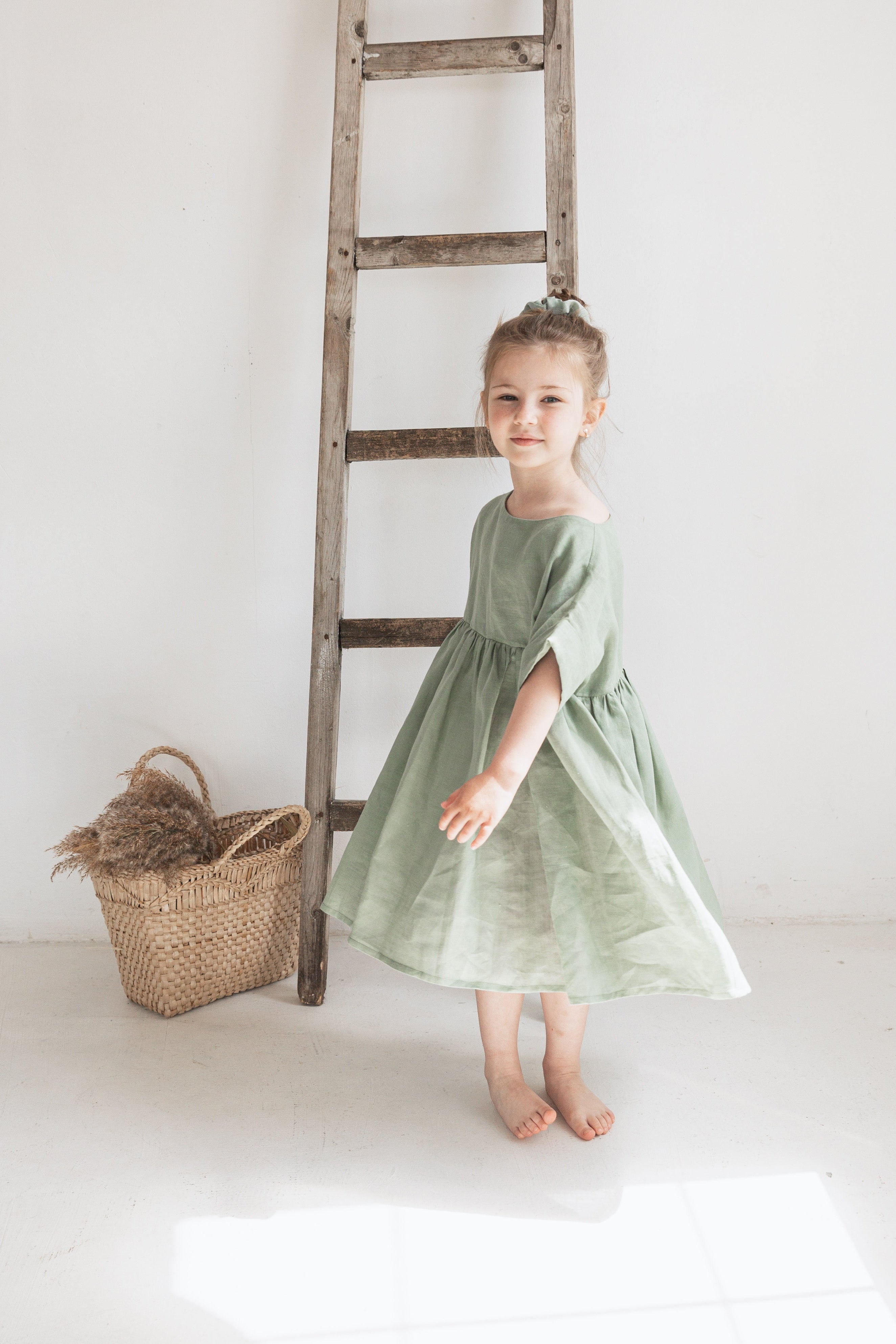 Side view of a child in an eco friendly ramie dress, lightweight nettle fabric kids clothing