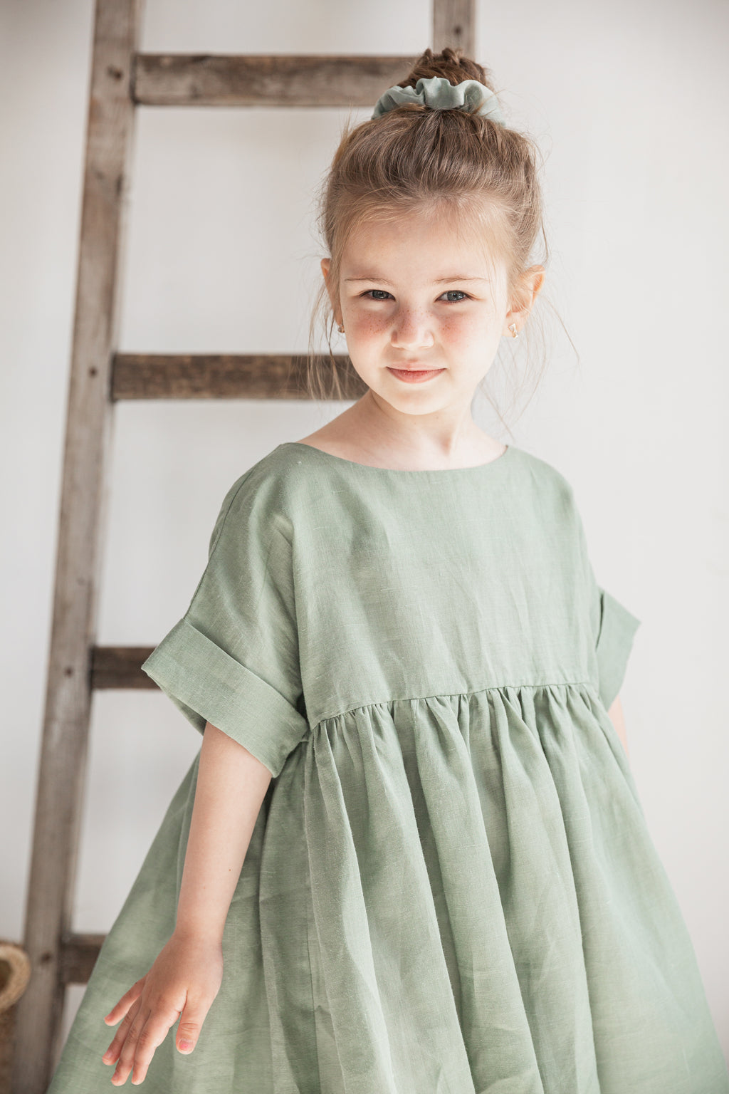 Girl wearing a natural ramie dress made of 100% nettle fabric, minimalist children’s summer outfit
