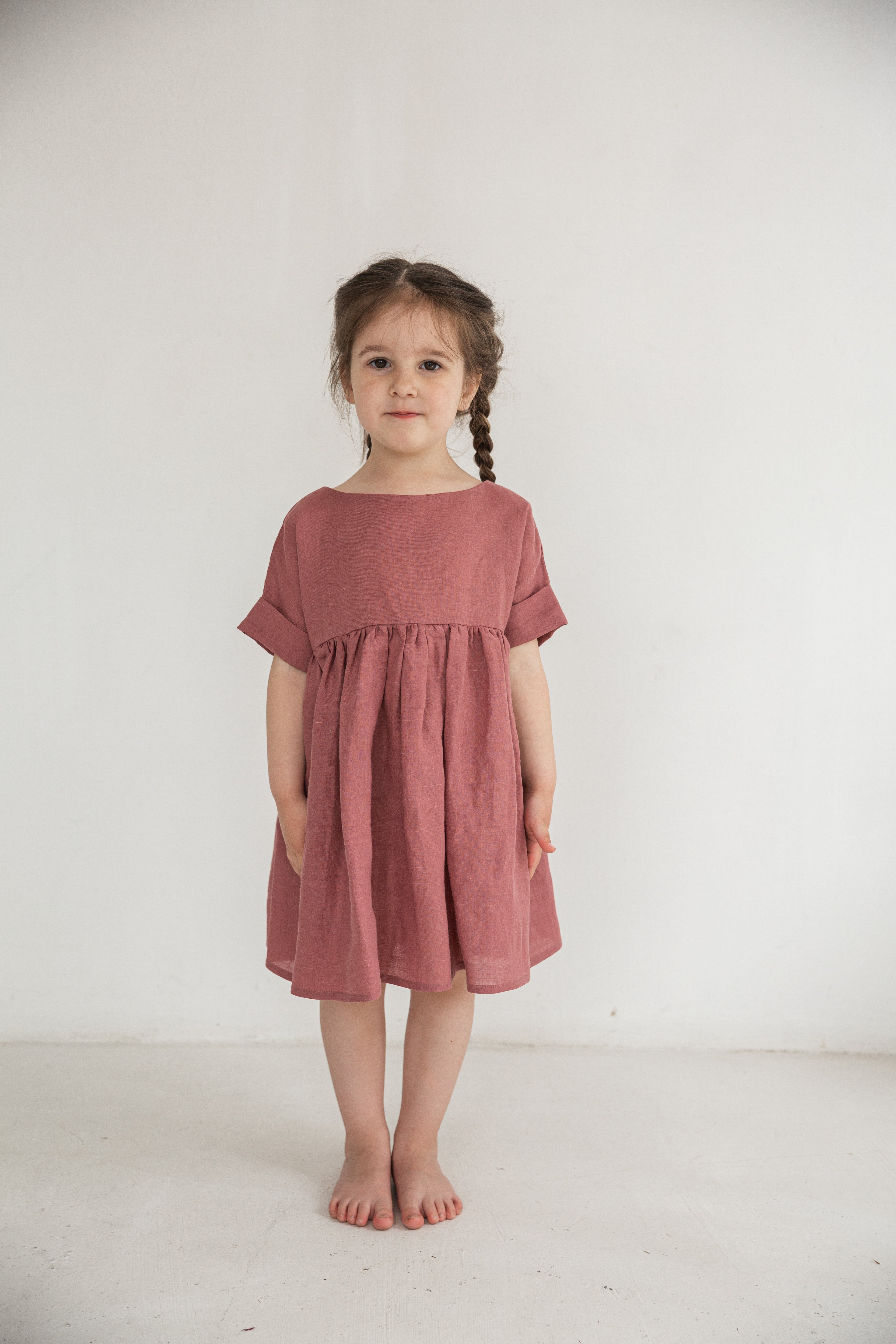 Girl wearing a natural ramie dress made of 100% nettle fabric, minimalist children’s summer outfit