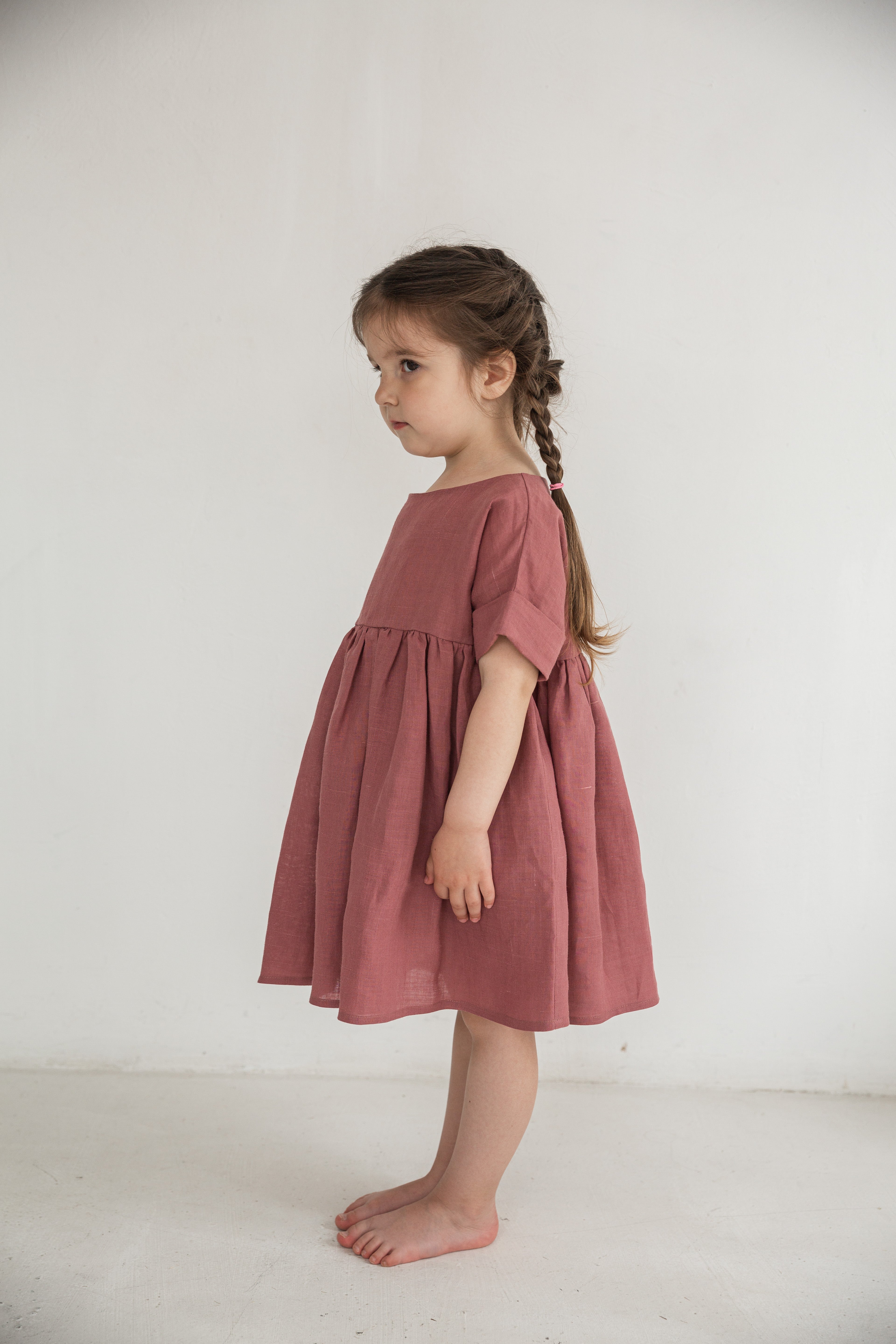 Side view of a child in an eco friendly ramie dress, lightweight nettle fabric kids clothing