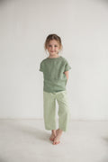 Eco-friendly children’s pants in natural color, perfect for summer outings.