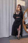 Black A-line linen skirt with elasticated waistband and front slit, made from 100% stonewashed linen.