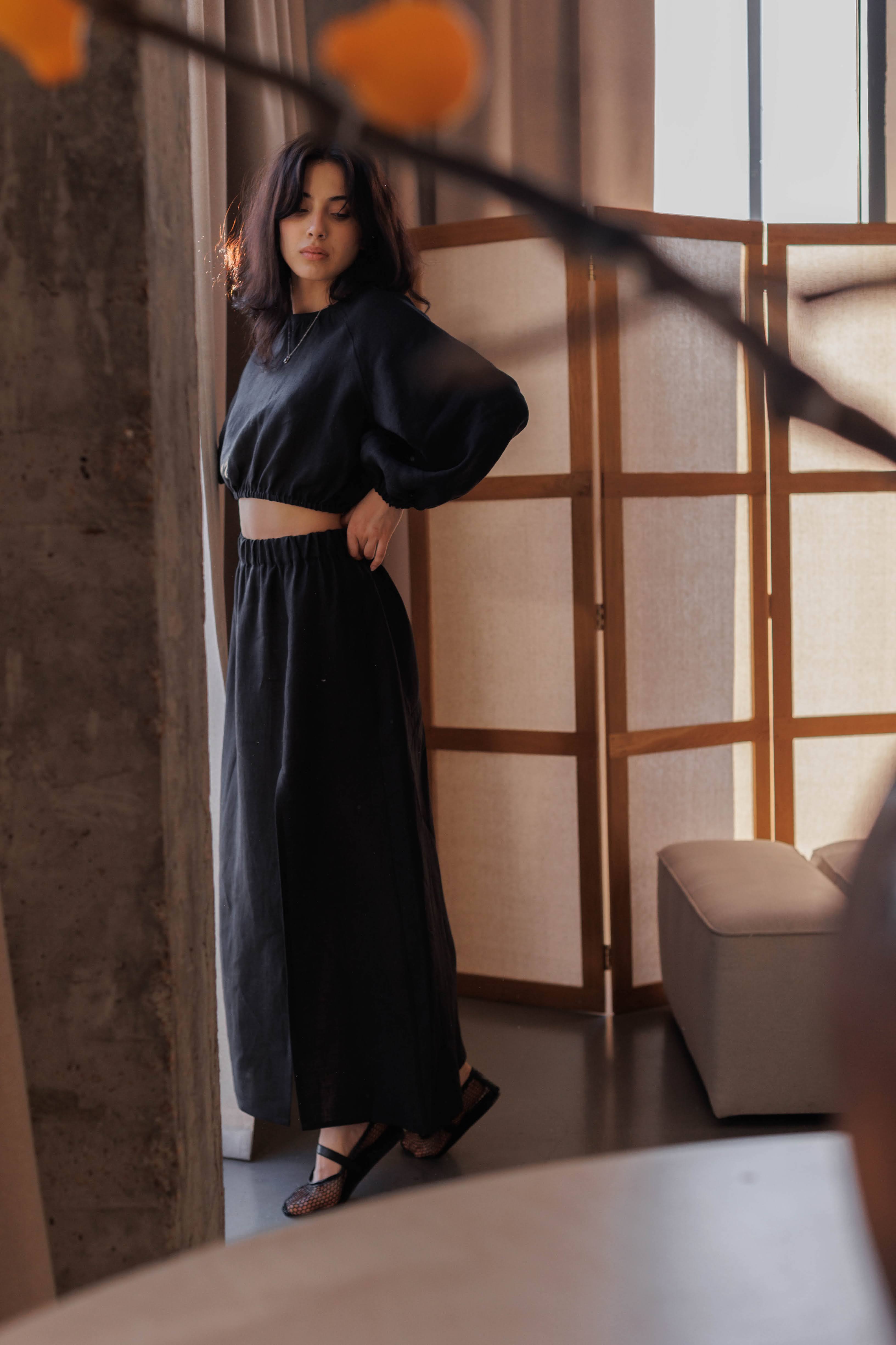 Versatile black linen A-line skirt, 100% stonewashed linen, with comfortable waist and front slit.