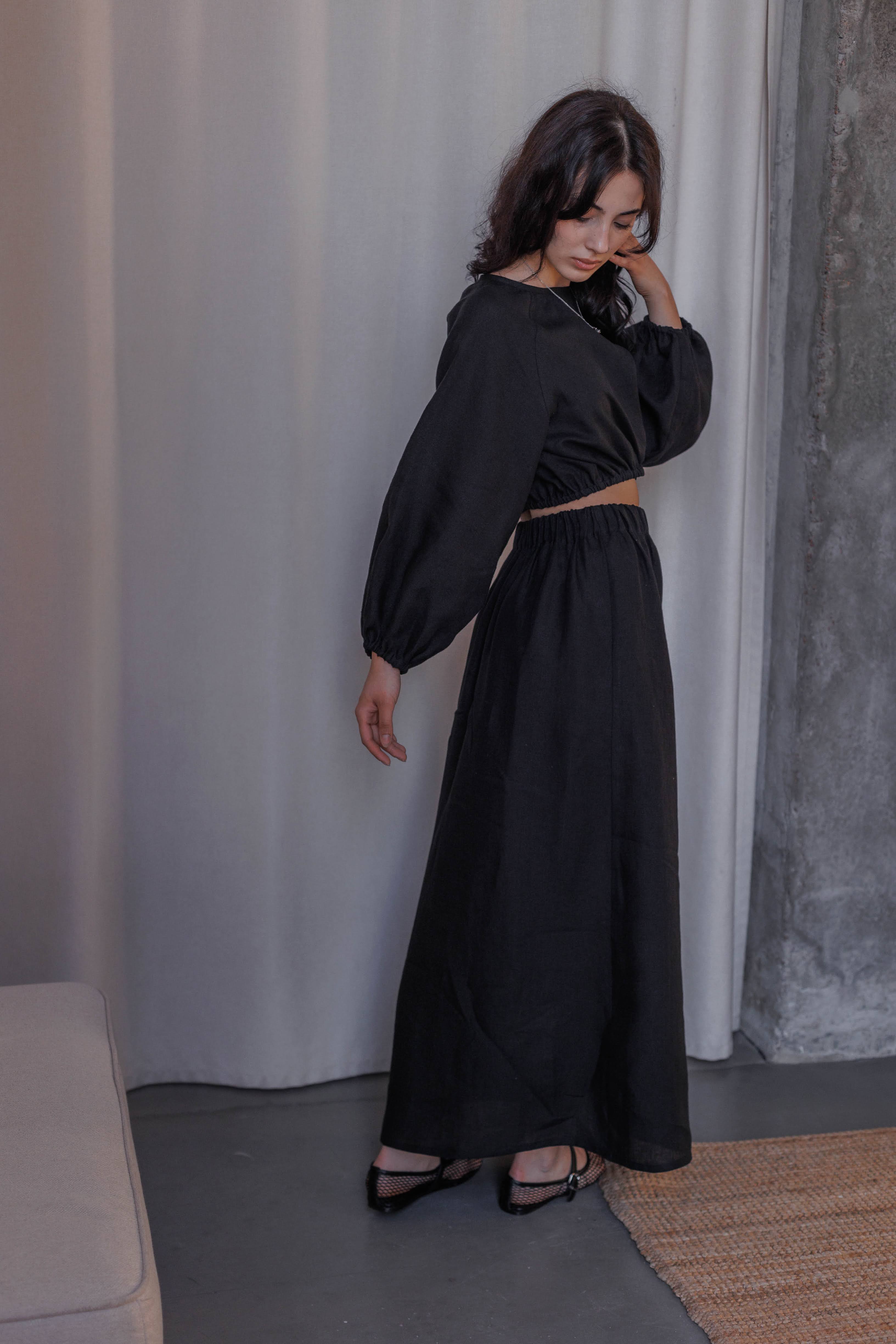 Versatile black linen A-line skirt, 100% stonewashed linen, with comfortable waist and front slit.
