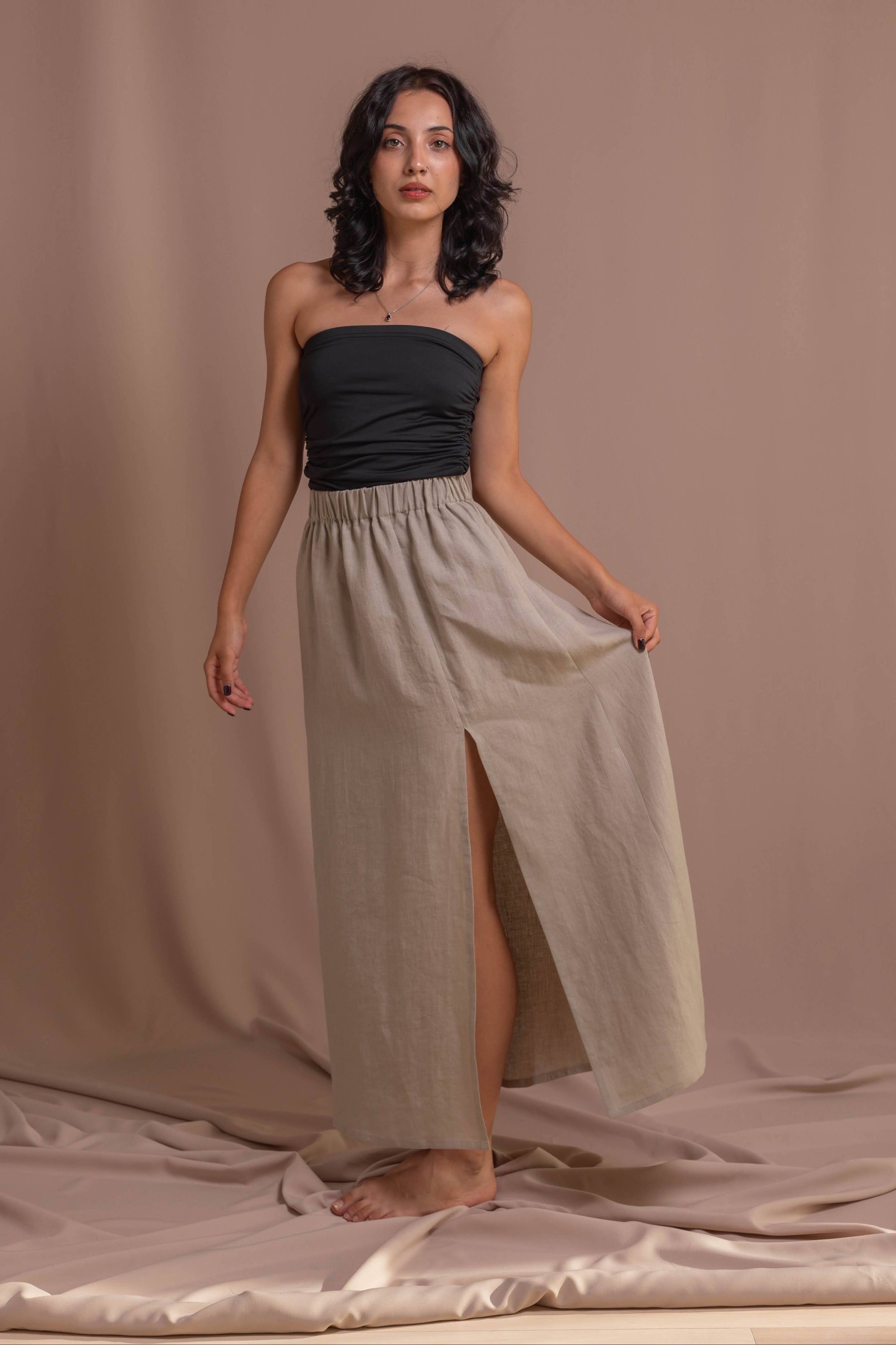 Women’s grey linen skirt, A-line silhouette, breathable stonewashed fabric, comfortable elasticated waist, and subtle front slit