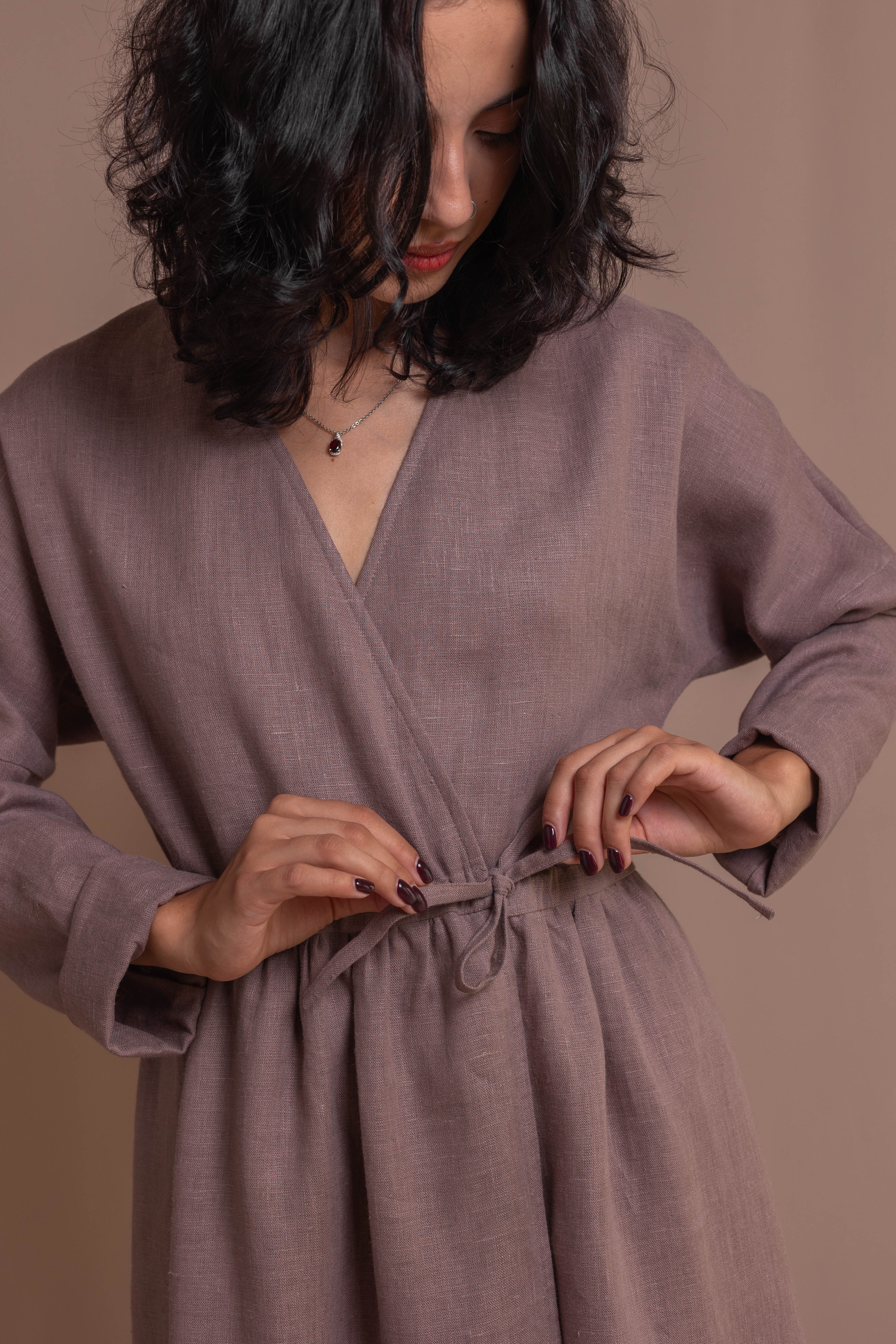 Detail of adjustable waist drawstring on a 100% linen wrap dress