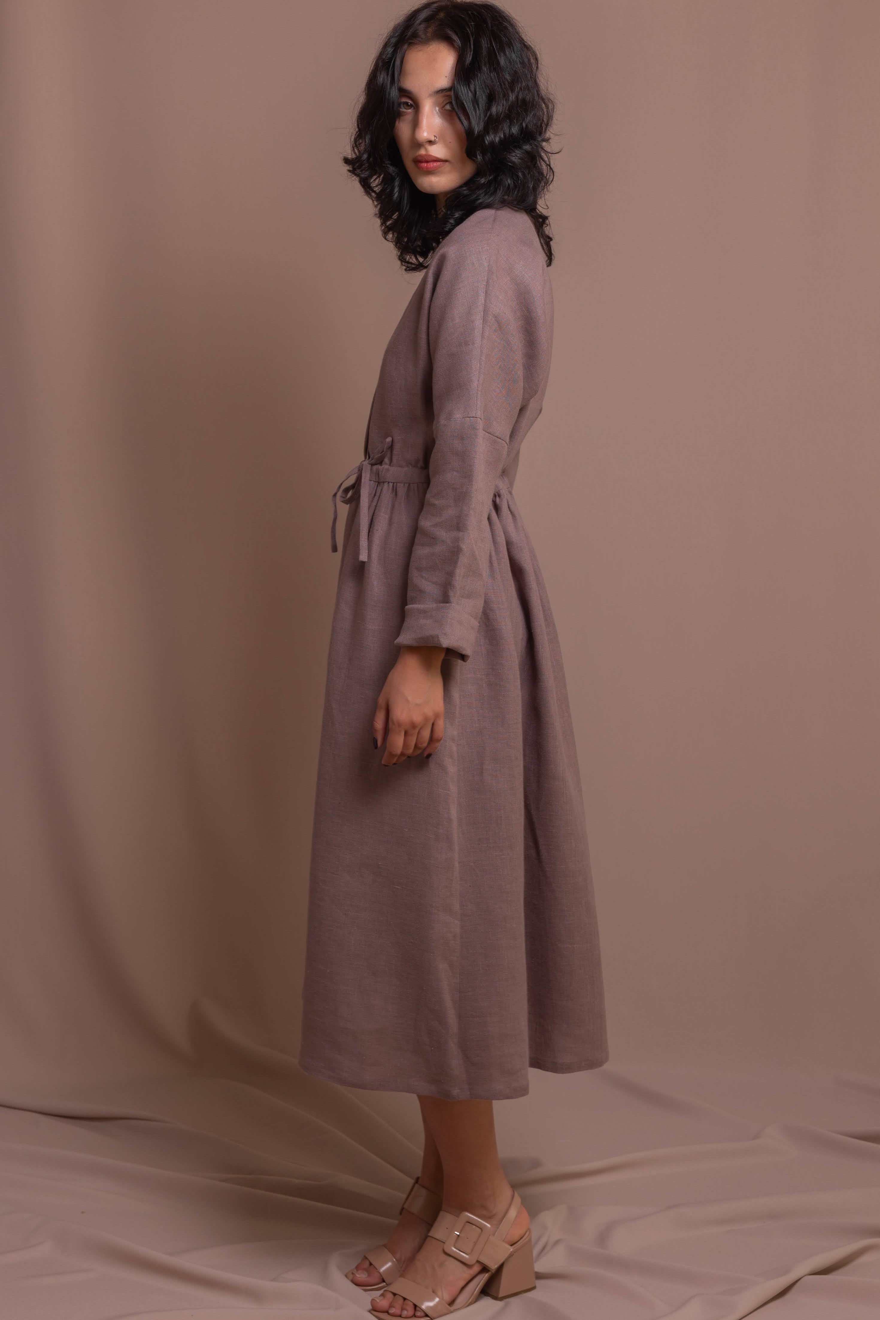 Side view of a 100% linen wrap dress with long sleeves and feminine silhouette