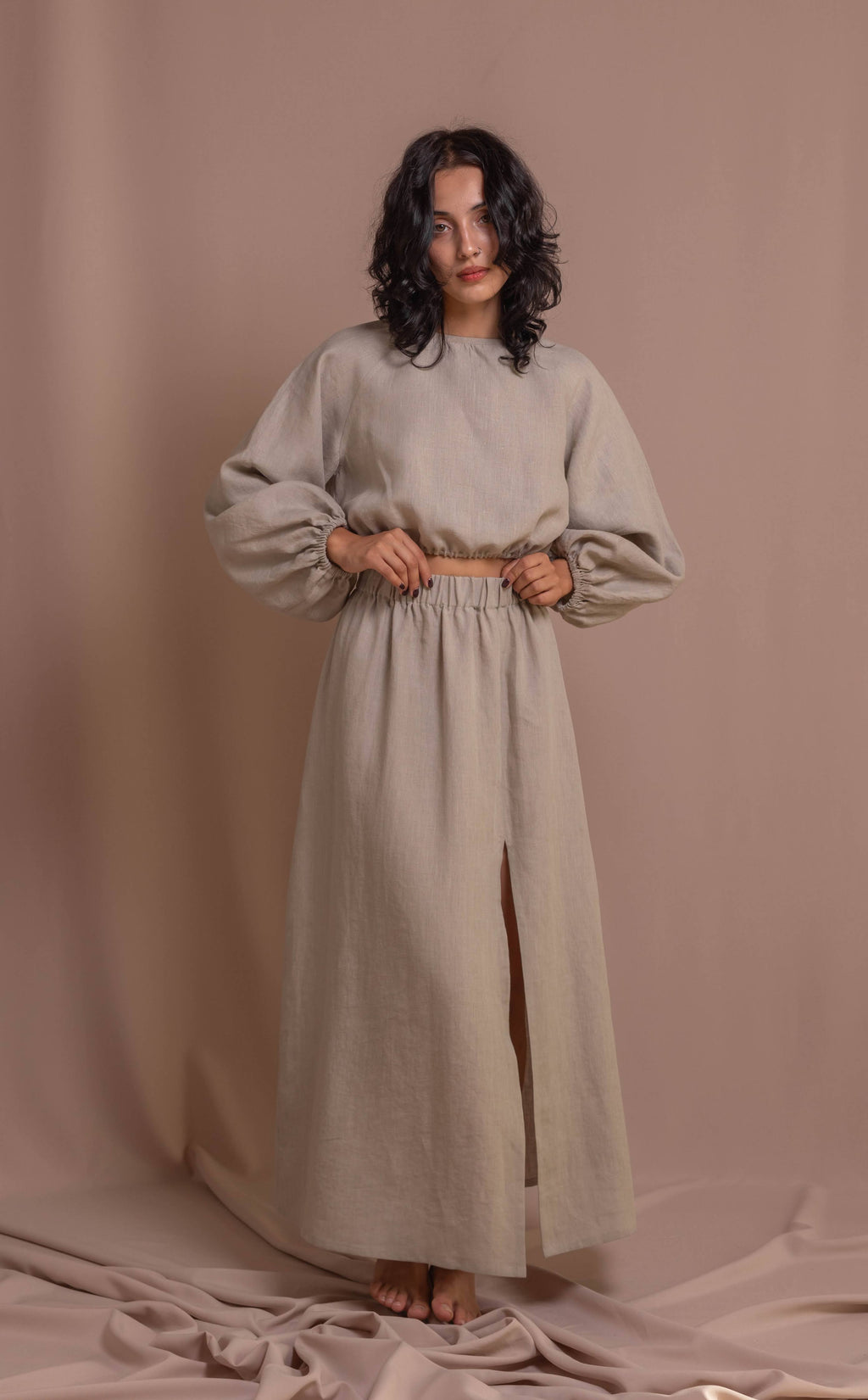 Handcrafted linen top with soft puff sleeves, elastic hem, and natural buttons, versatile for pairing with skirts or pants
