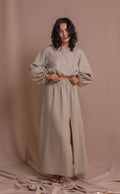 Handcrafted linen top with soft puff sleeves, elastic hem, and natural buttons, versatile for pairing with skirts or pants