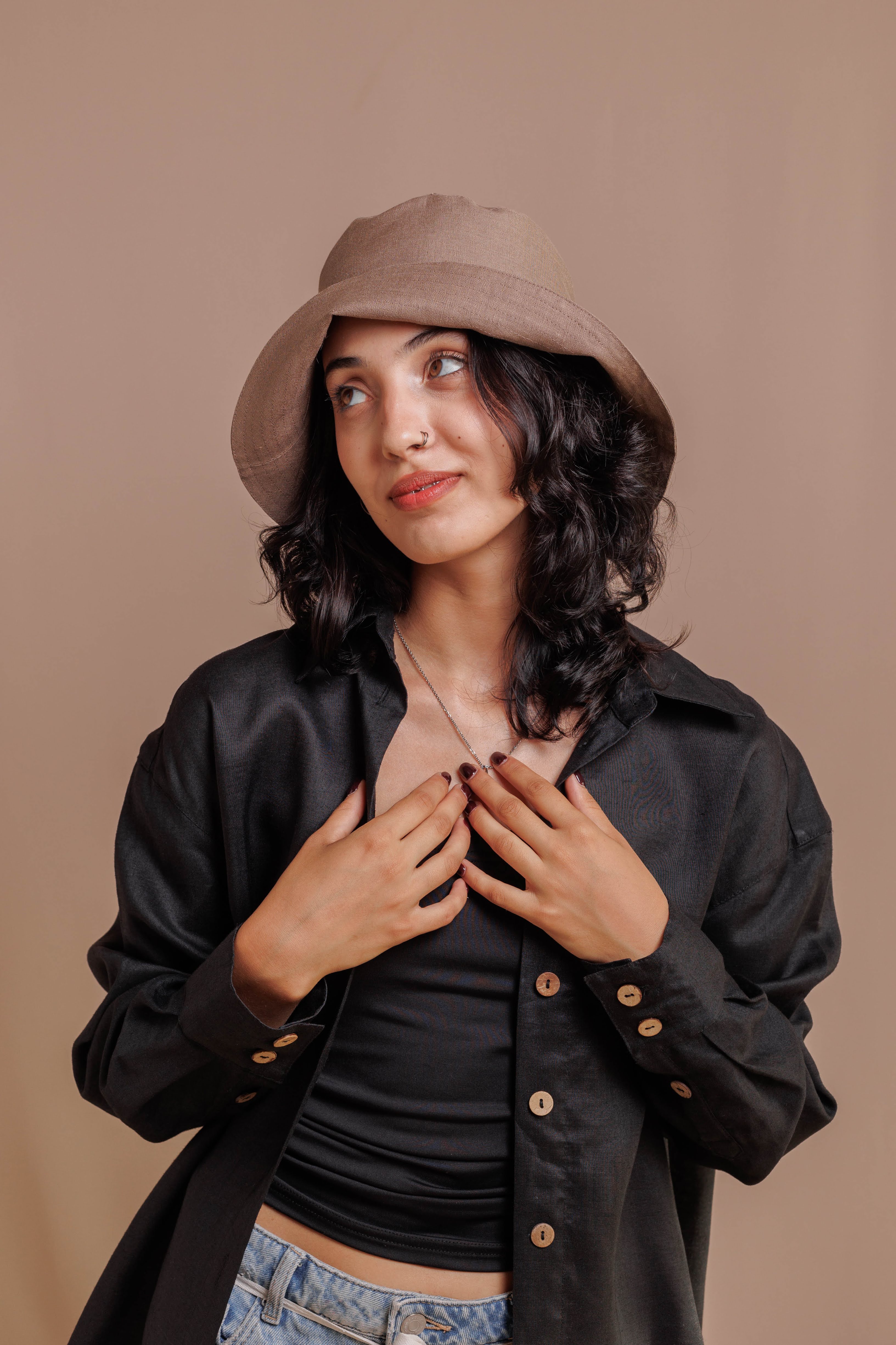 Natural linen bucket hat folded up, perfect for travel and everyday wear