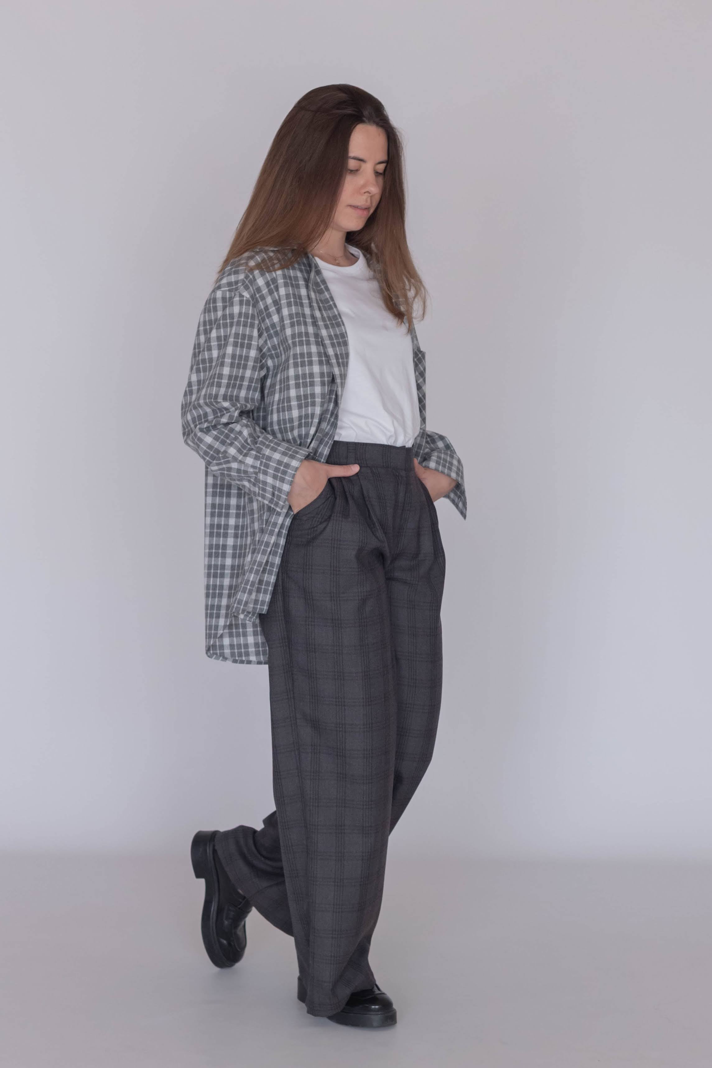 Model wearing women’s wool plaid trousers with classic checked pattern