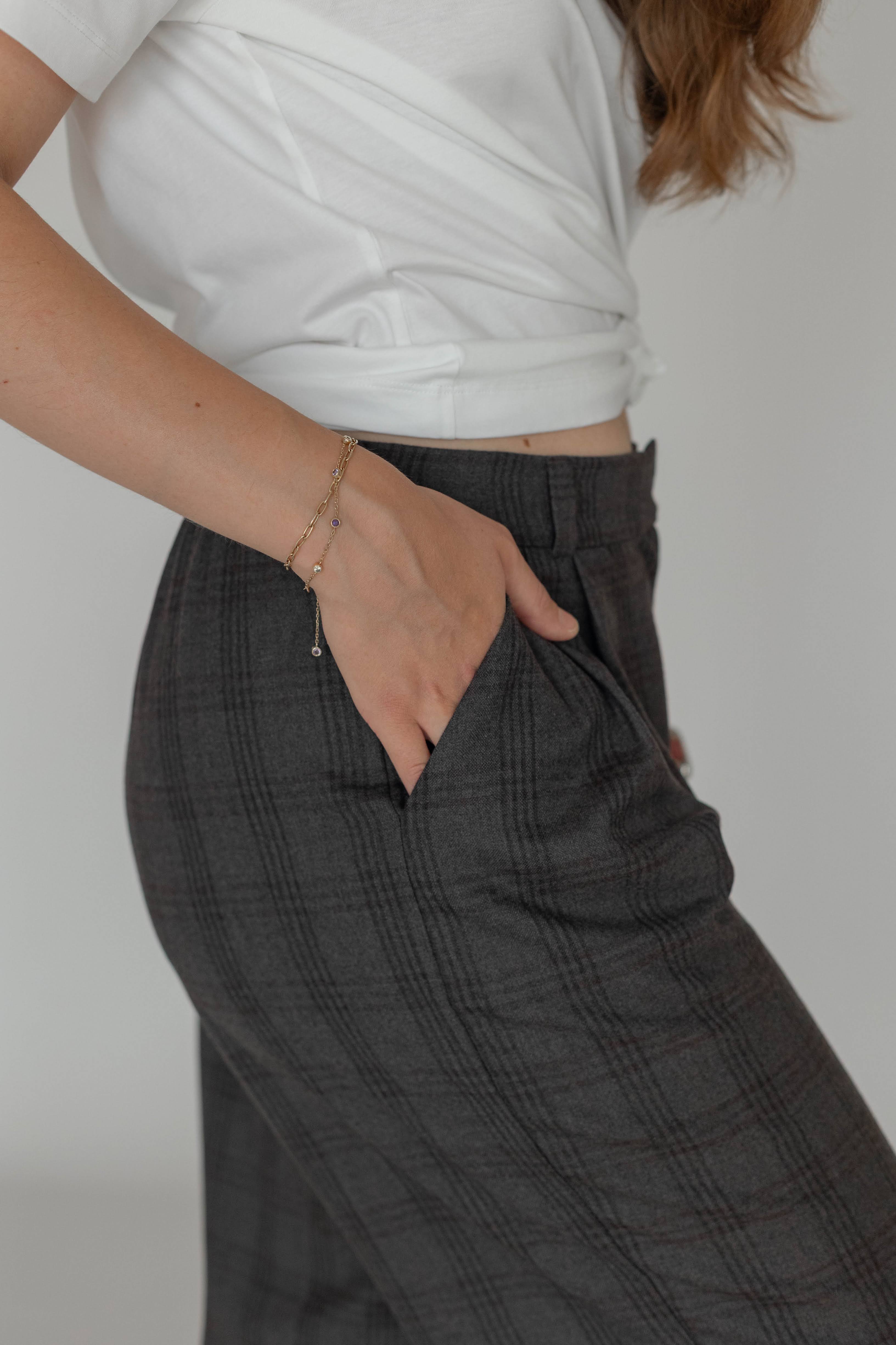 Detail of 100% wool plaid trousers with front pleats