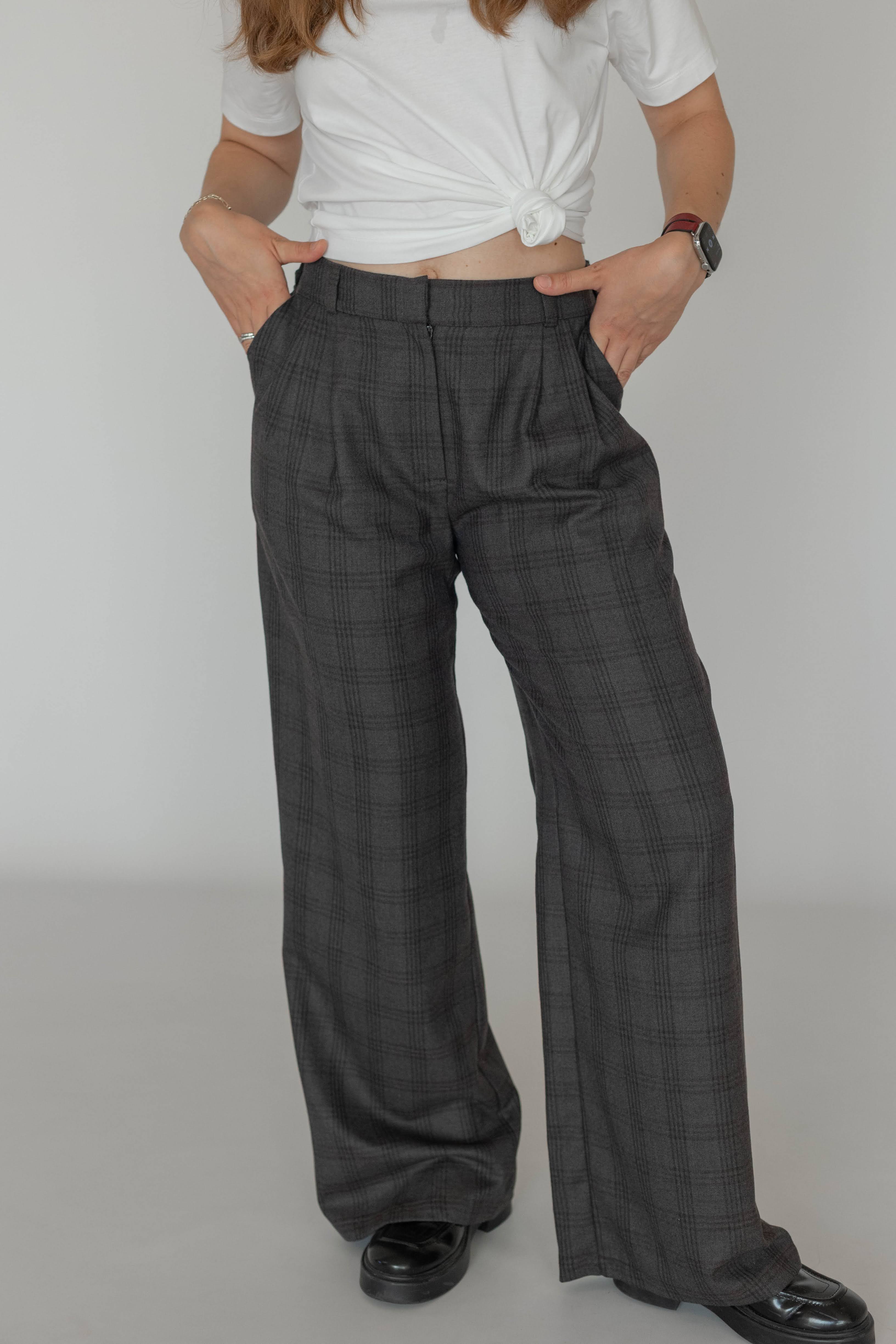 Model wearing women’s wool plaid trousers with classic checked pattern